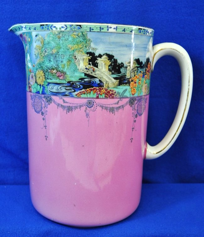 ROYAL STAFFORDSHIRE WILKINSON LAVENDER FLORAL PITCHER: Offered for your bidding consideration this stunning 10 inch Royal Staffordshire Wilkinson Milk Pitcher, in an oriental scenic rim floral pattern with a lavender base , the mark was first used in 1895