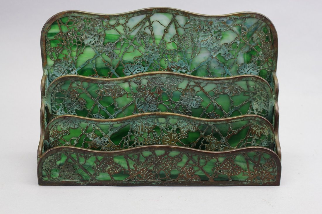 Tiffany Studios Art Nouveau Letter Holder (as is): Art nouveau Tiffany letter holder. It is in the intricate Grapevine design and circa 1920s. Holder has bronze metal on both sides of the swirl green slag glass. It is marked on the bottom - Tiffany St