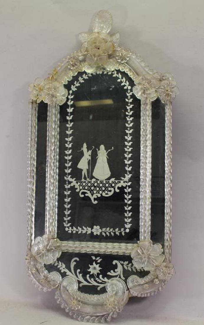 Antique European Figural Mirror: Antique European Figural Mirror. Having glass flower decoration near crest. Size: 25.5 x 12.5 inches.