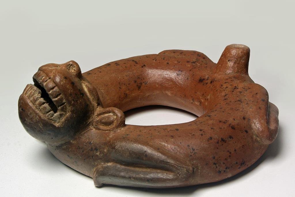 Pre-Columbian Circular Body Canine Effigy Vessel: Pre-Columbian Circular Body Canine Effigy Vessel. Maya. Preclassic period 600-100 BCE. Guatemala Buff earthenware with burnished red brown slip Approx Size: 3.75 x 11 in. Condition: Intact with libera