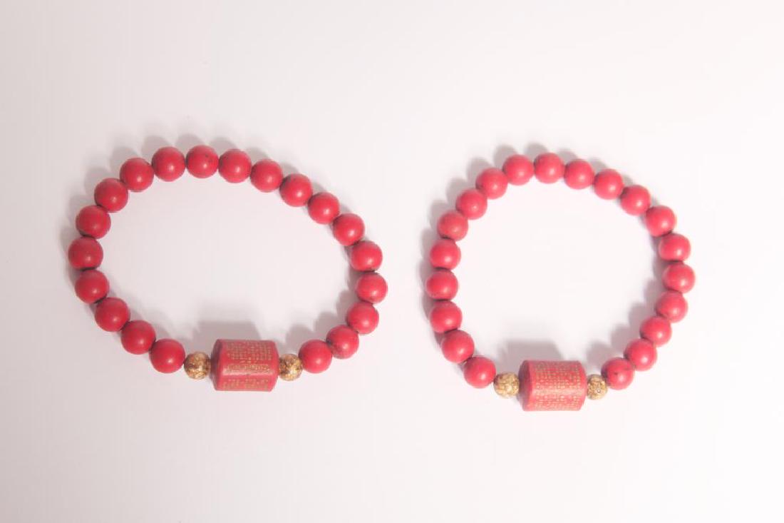 (2) red beaded bracelets: (2) red beaded bracelets