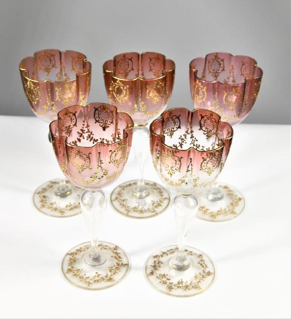 Five Moser (5) wines with hollow-blown stems: Five (5) wines with hollow-blown stems, cranberry shading to clear, signed “Moser M M Karlsbad“ with wine cup design between the M’s, 6 7/8” h x 2 7/8” base x 2 15/16R
