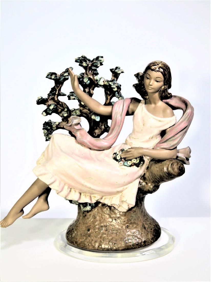 Lladro Porcelain Figurine of Young Girl, Day Dream: Lladro Porcelain Figurine of Young Girl, Day Dream_x000D_ Delicate figurine of a woman reclining in a tree. Handmade in Spain. Based in Tavernes Blanques, Valencia in Spain, LladrÃ³ produces exquisi