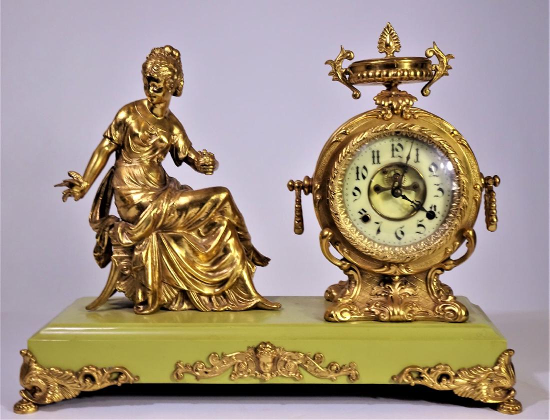 1900 Gilt Bronze New Haven "Flower Girl" Clock: 1900 New Haven Clock. "Flower Girl" Gilt Bronze. 16" h x 26" w. 6 in pocelain dial. 8 day 1/2 strike on cathedral gong. Size: 16 x 20 1/2