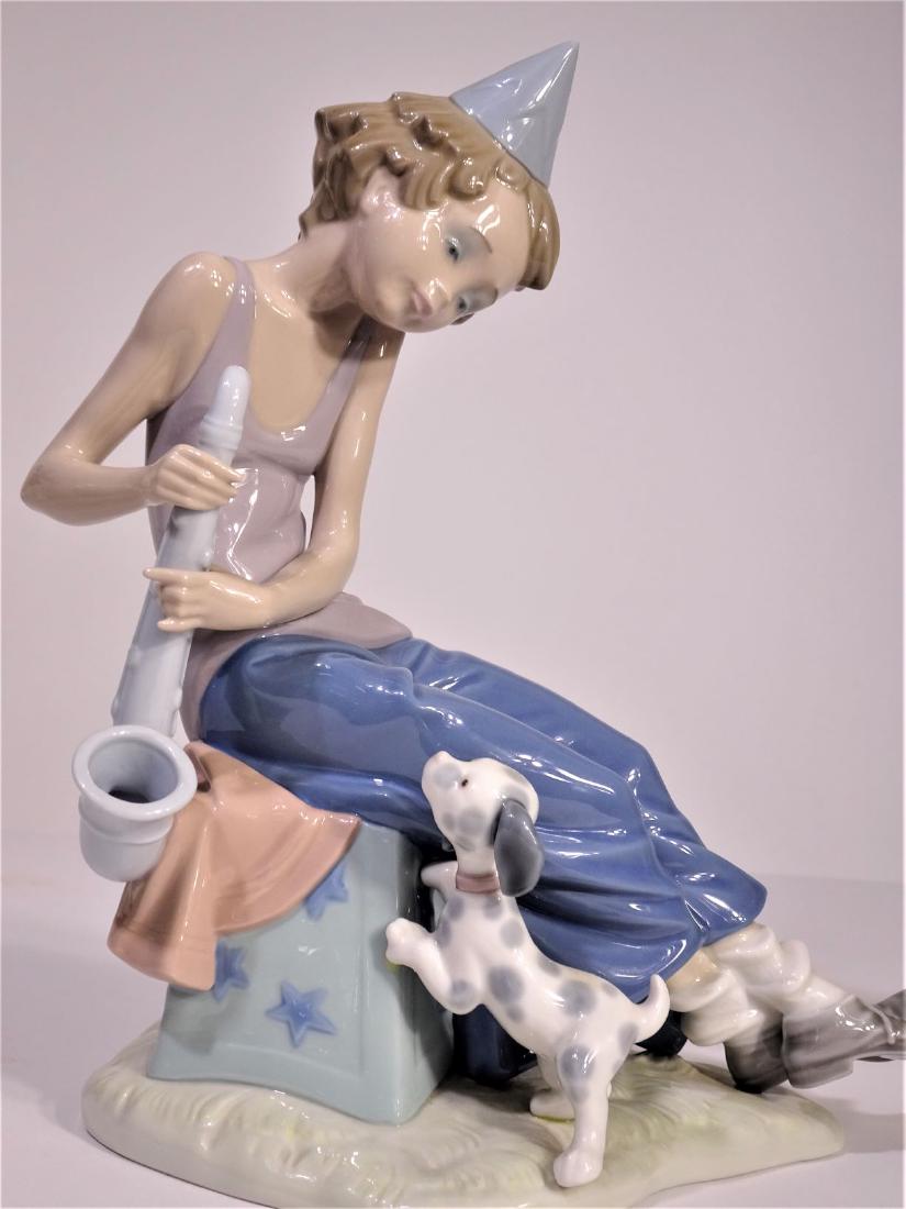 Lladro 'Clown with Saxophone' Figure: Repair to foot that has been chipped off. Based in Tavernes Blanques, Valencia in Spain, Lladró produces exquisite porcelain figurines. The company was founded in 1953 by three brothers and began by 