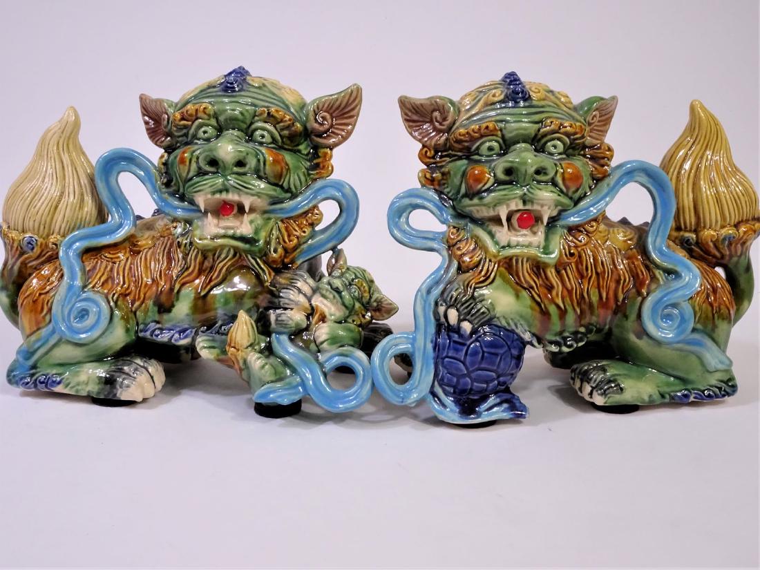 (2) Chinese Glazed Imperial Guardian Lions: Size: 9 1/2 in L x 5 1/4 in W x 7 1/4 in H. Chinese or Imperial guardian lions, also known as lion dogs or foo dogs in English, are a traditional Chinese architectural ornament. Typically made of ston