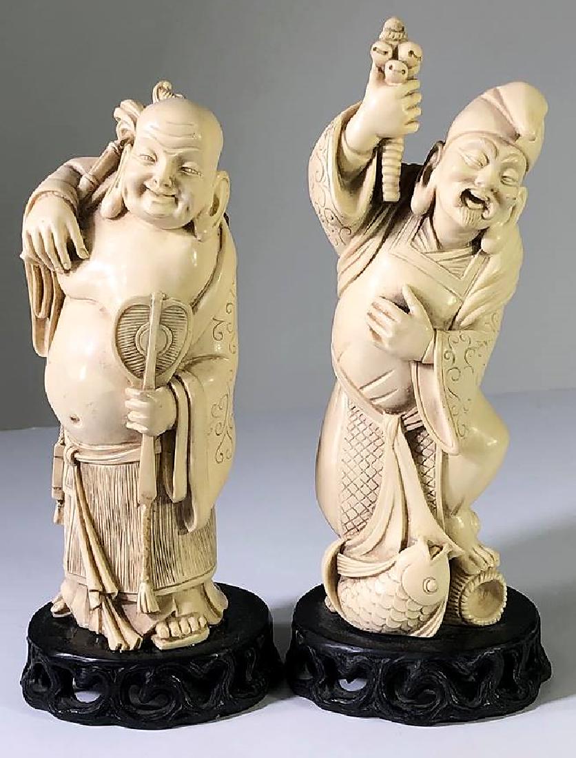 Carved Japanese Lucky Gods: Carved Japanese Laughing Lucky Gods1-Buddha holding an Oogi & Manon Koi. Size: 9 1/2 x 4 in.2-Fishing EBISU standing upon a koi and basket Signed under base. Size: 10 x 4 in. CONDITION- By registering