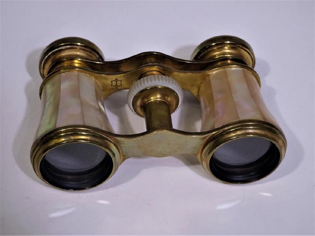 Mother-of-Pearl and Brass Opera Glasses: Mother-of-Pearl and brass opera or theatre glasses. There is a small hallmark on the brass piece where the focus is adjusted, but we have not been able to identify the hallmark. The size is 2 1/2 x 3 