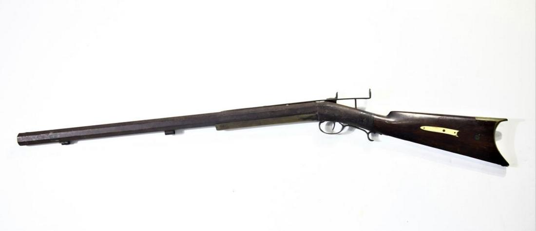 Mid 1800's Muzzle Loading Hunting Rifle: This is a single-shot percussion cap front- loading rifle, probably made during the mid 1800's, and possibly used for birding or fowling. It has an extended arm with a small eye-hole in the back and a