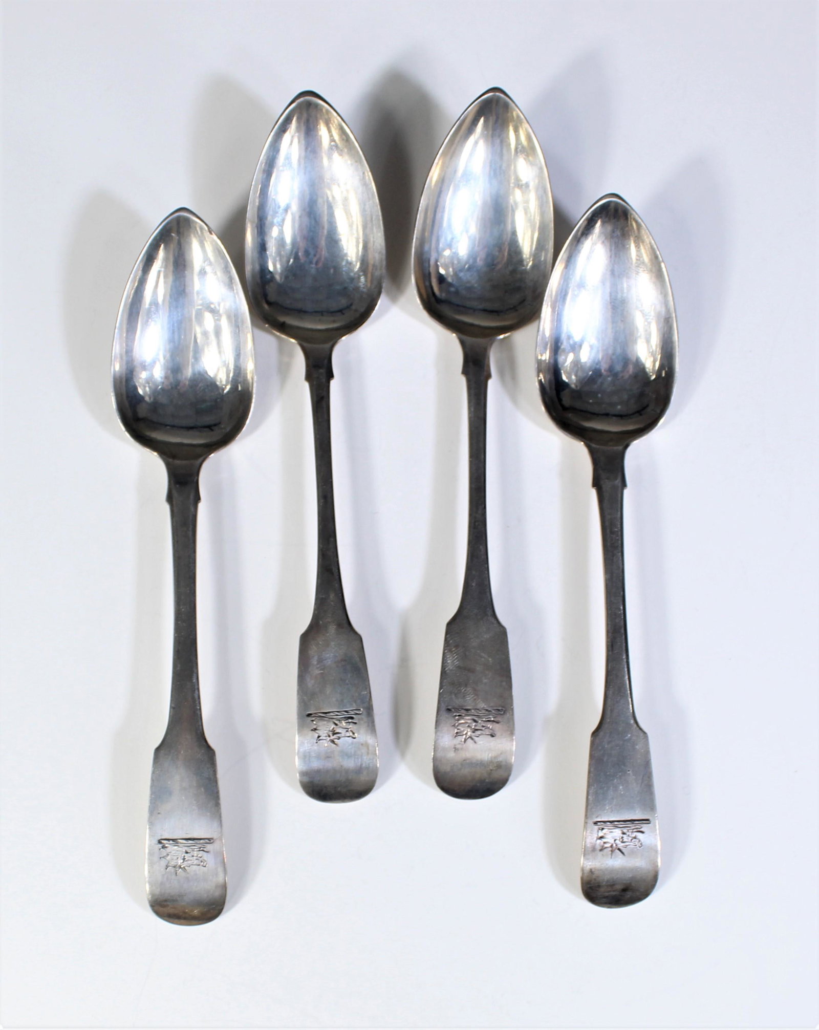 4 Antique English Silver Engraved Spoons: SN with English hallmarks stamped on back. Engraving of wolf or boar on handle. Measurements: Length - 5 1/2 in. Weight - 2.6 ozt.