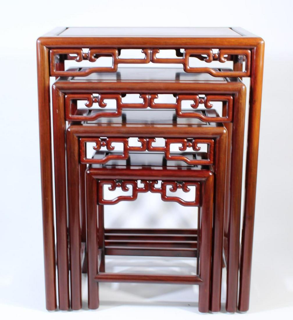 19th C. Set of 4 Chinese Carved Nesting Tables: Size (largest): 20 x 14 x 26 in. Beautifully carved nesting tables. Each piece has carved wooden detailing. Minor marks on the tops of the tables, good condition overall.