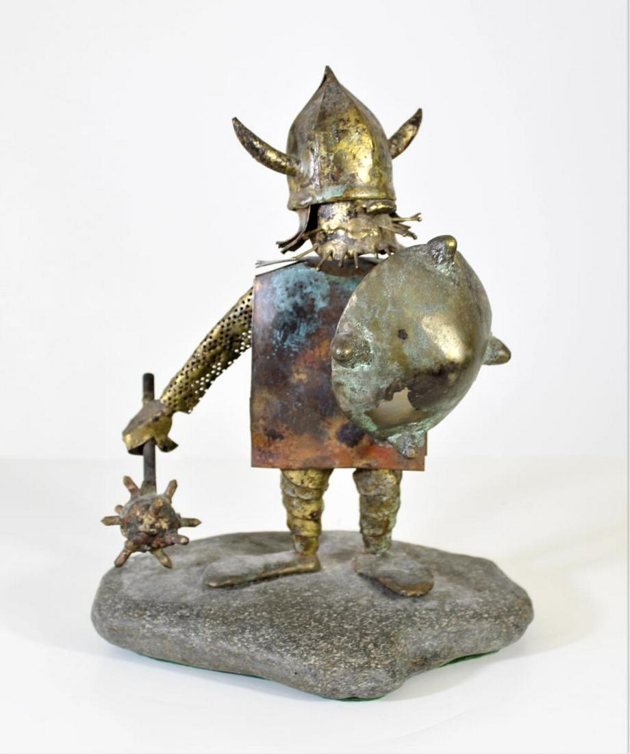Brass Viking Sculpture on Stone Base: Size: 11 1/2 in. H x 9 x 7 in. Brass Viking Figure holding a mace and a shield. This is a very interesting piece because the viking's beard is made out of nails coming out of his chin.