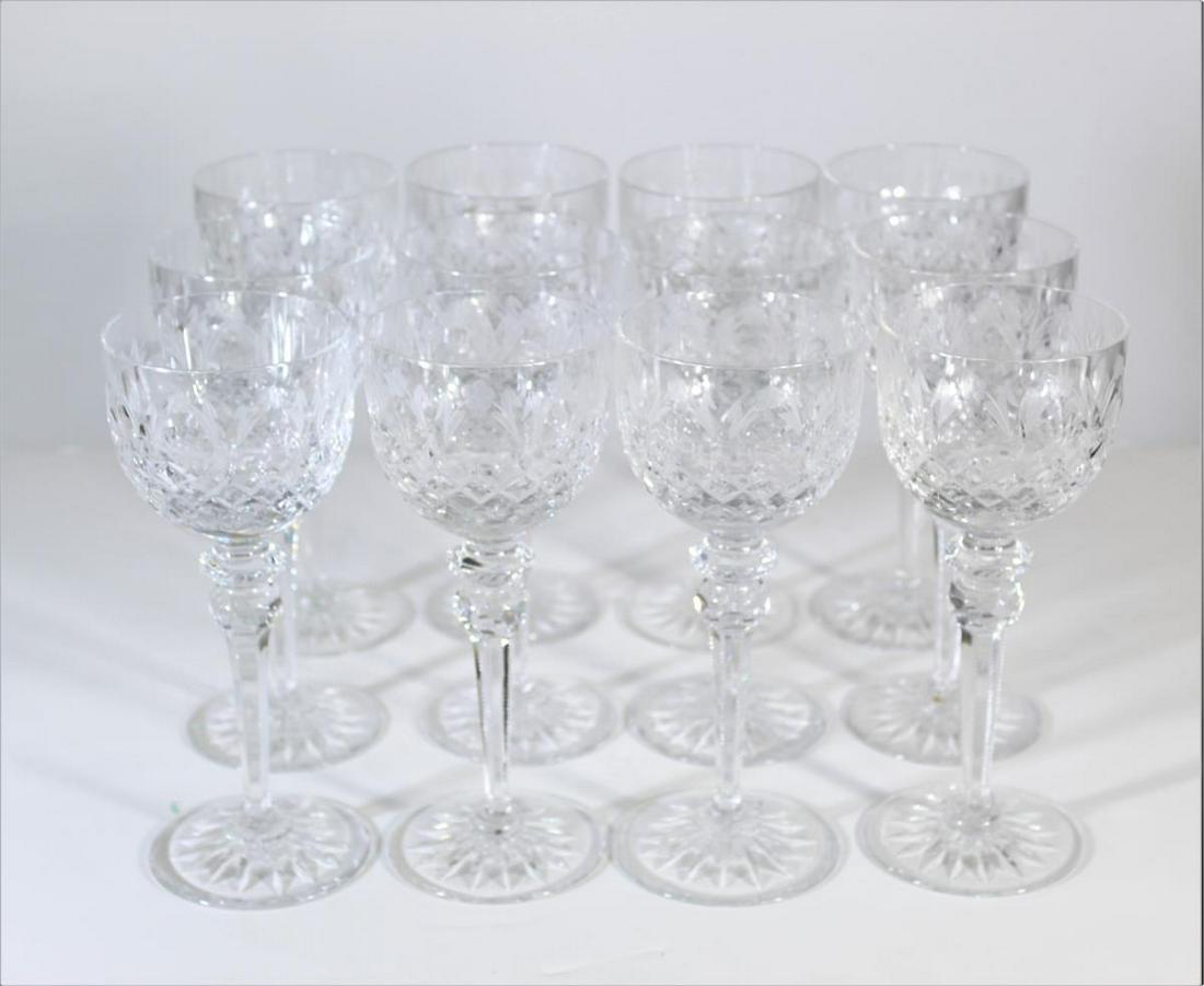 (12) Etched Crystal Wine Glasses: 12 glasses, 8 in. tall. Maker on the underside. Etched design with flowers and diamond shapes.