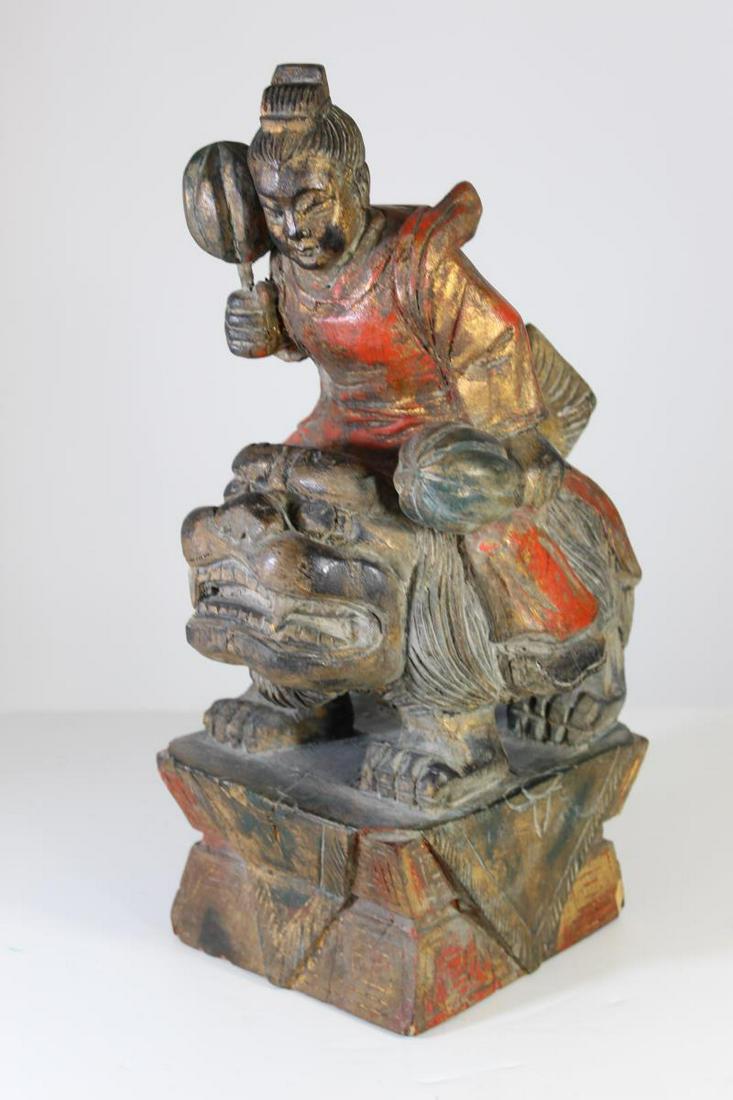 19th C. Chinese Hand Carved Warrior Riding Foo Dog: Size: 17 in. H x9 W. Great Chinese carving of a warrior holding two weapons on top of a foo dog.