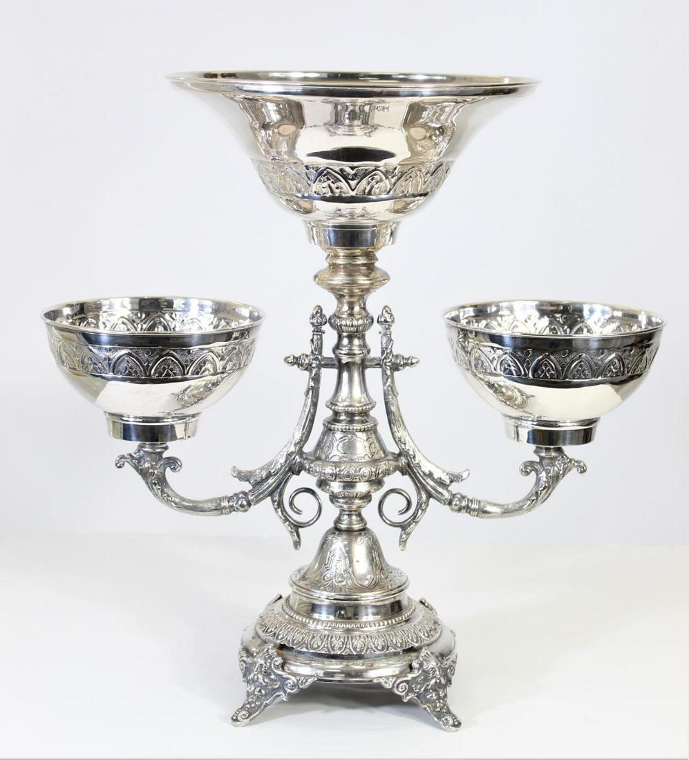 Grand Victorian Style Silver Plate Epergne: Size: 16 3/4 x 16 3/4 in. Victorian style silver plate epergne, urn form supporting three baskets.