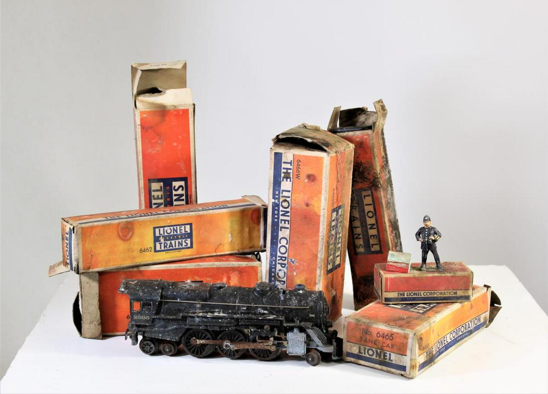 Lionel & American Flyer Train Set Pieces: 4 boxes of various pieces. Includes trains, tracks, and an iron train bridge from Lionel and American Flyer. Various sizes.