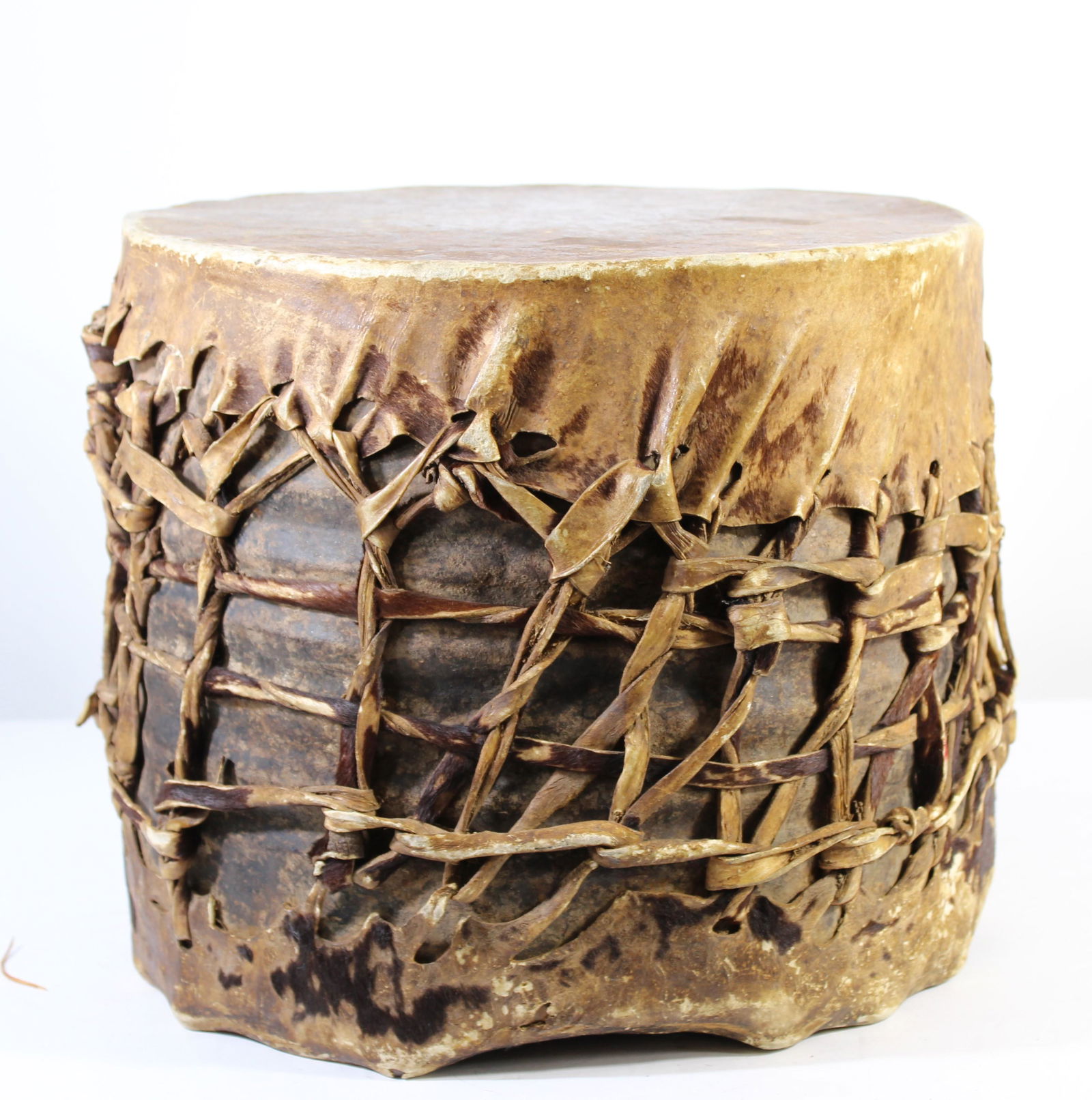 African Dance Drum from Early 1900's: An African dance drum from the Central African Republic. The drum is carved from one piece of wood and the drum skin is made from animal hide stretched taut over the sides and held in place with strap