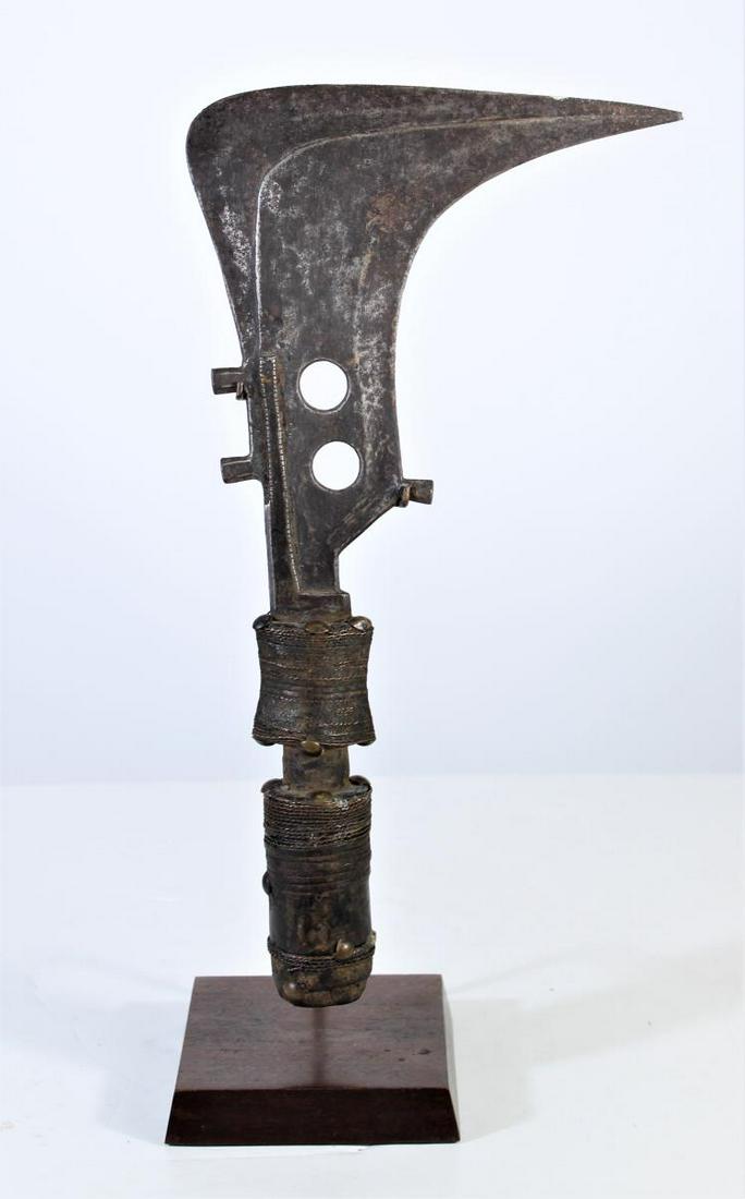 African Mangbetu Knife - Congo: This sickle-shapped knife, although reminiscent of a throwing knife, was not used as a weapon but as a form of currency and as a symbol of rank among the Mangbetu people. The blade is of locally forge