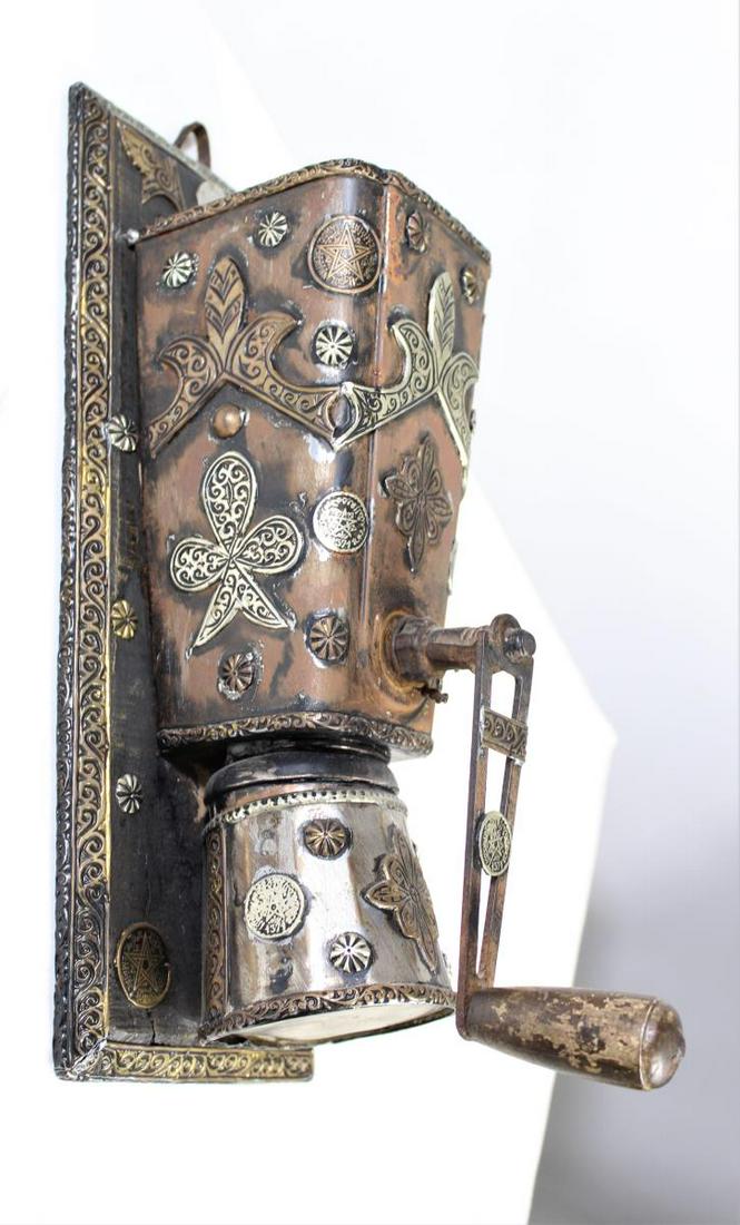 Antique Moroccan Grinder: Adorned with Moroccan Francs. Wood backing with leather loop for hanging. Size: 14 1/2 x 6 x 6 in.
