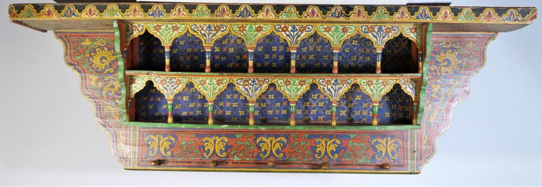 19th C Indonesian Hand-Painted Wood Wall Shelf: Elaborate design hand painted wooden shelf compromising of 3 layers and knobs on the bottom.Elaborate design hand painted wooden shelf compromising of 3 layers and knobs on the bottom. Size: 51 x 10 x