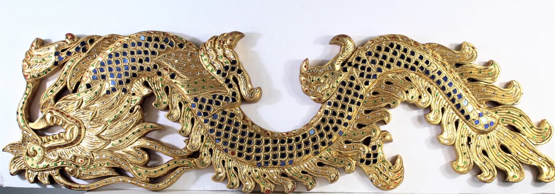 Gilt Wall Hanging Dragon: Made of wood. Gilt painted and adorned in polished colored stones. Measurements: 11 x 38 1/2 in.