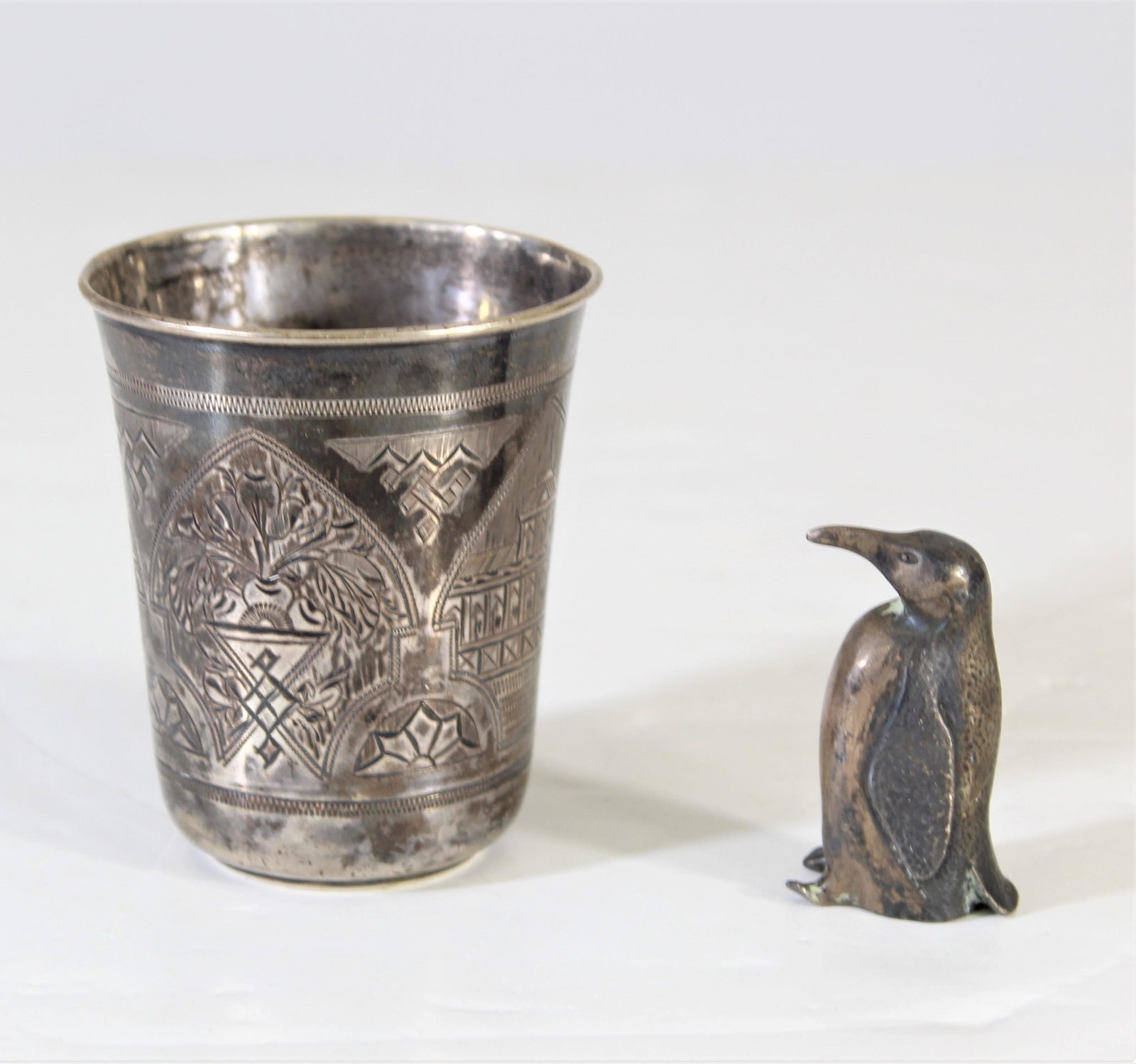 Sterling Silver cup and Penguin: Weight: 5.37 ozt. Cup is marked on bottom and penguin is marked sterling.