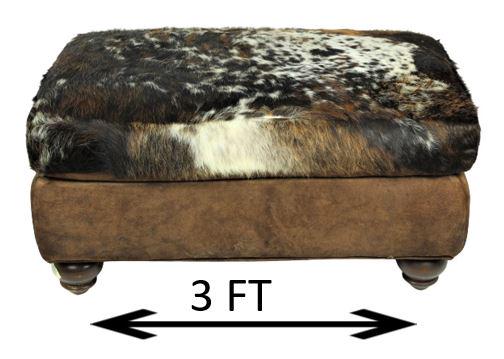 Cow Hide Ottoman: Substantial cowhide ottoman, King Ranch Saddle Shop.Size: 37 x 23 1/2 x 18 in. Please note that all sales are final and no refunds will be given under any circumstances. Sarasota Estate Auction provid