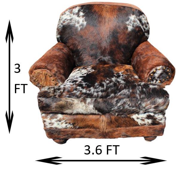 Cow Hide Arm Chair: Cow hide and suede arm chair with nailhead trim, by King Ranch Saddle Shop.Measurements: 43 1/2 x 36 1/2 x 37 in. Please note that all sales are final and no refunds will be given under any circumstan