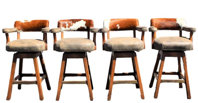 Set of (4) King Ranch Cowhide & Leather Barstools: Set of four cowhide and leather barstools, by King Ranch Cowhide. Good condition, light scratches. Measurements: 26 x 21 1/2 x 40 1/2 in. Please note that all sales are final and no refunds will be gi