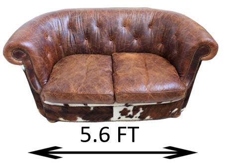 King Ranch Cowhide and Leather Loveseat: Southwestern cowhide and leather loveseat with nailhead trim. Well-worn seat cushions. Dimensions: 68 x 42 x 35 in. Please note that all sales are final and no refunds will be given under any circumst