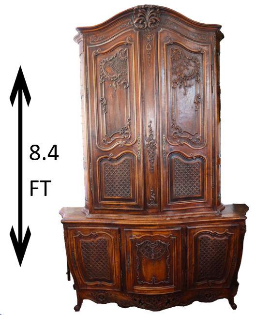 18th C French Buffet Du Corps: Exceptionally carved (2) piece French provincial furniture. Overall condition good. Original color and locks. Purchased in New Orleans. Measurements: 66 x 19 x 101 in. (Approximately 8 feet tall.) Ple