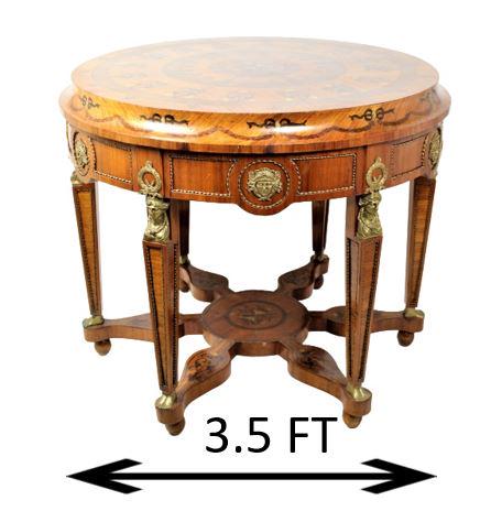Inlaid Center Table, French Empire Style: Beautiful 42" round inlaid table, classical Egyptian revival style. This exquisite center table features bronze mounts and figural busts. Inlaid six point stretcher, supported by six ball feet. Size: 