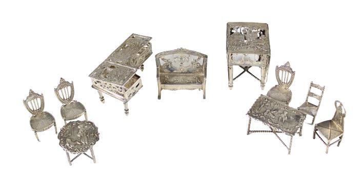 (10) Continental Sterling Miniature Furniture: Collection of 19th century sterling miniature furniture consisting of: a piano and chair; drop leaf dining table; writing table; round breakfast table with three chairs; and love seat with one chair.P