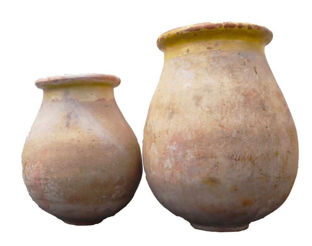 Pair of French Terracotta Olive Jars: Large and heavy olive jars made of clay. Remnants of a prior glaze on the rims. Commensurate with age and use. Larger one: 29 x 22 in. Other: 24 x 18 in.