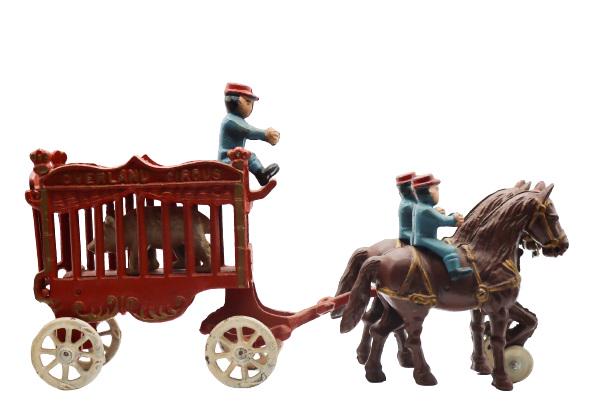 Vintage Overland Circus Cast Iron Toy: Reproduction cast iron toy of an Overland Circus horse drawn wagon with three men and two horses, inside the caged cart is a pacing bear. It is likely made by the Kenton Toy Manufacturing Company of K