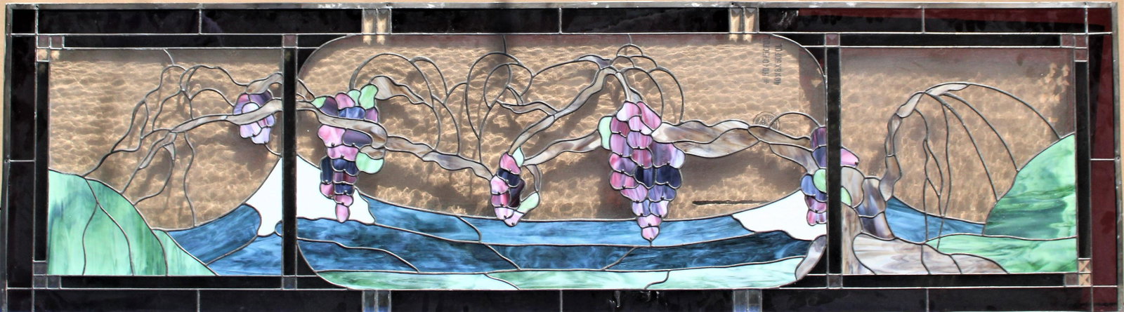 Large Transom Stained Glass Window Panel: Beautiful stained glass image of grapes on the vine with a mountain landscape behind. Border is a lovely wine color. Approx. size: 84 x 24 in.