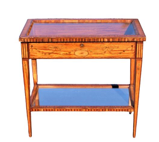 Antique Satinwood Lift-top Console Table: Antique lift-top console table, tapered legs, lower glass shelf. Commensurate with age, small repair to one leg. Dimensions: 17x 31 x 30 in. Please note that all sales are final. No refunds will be gi