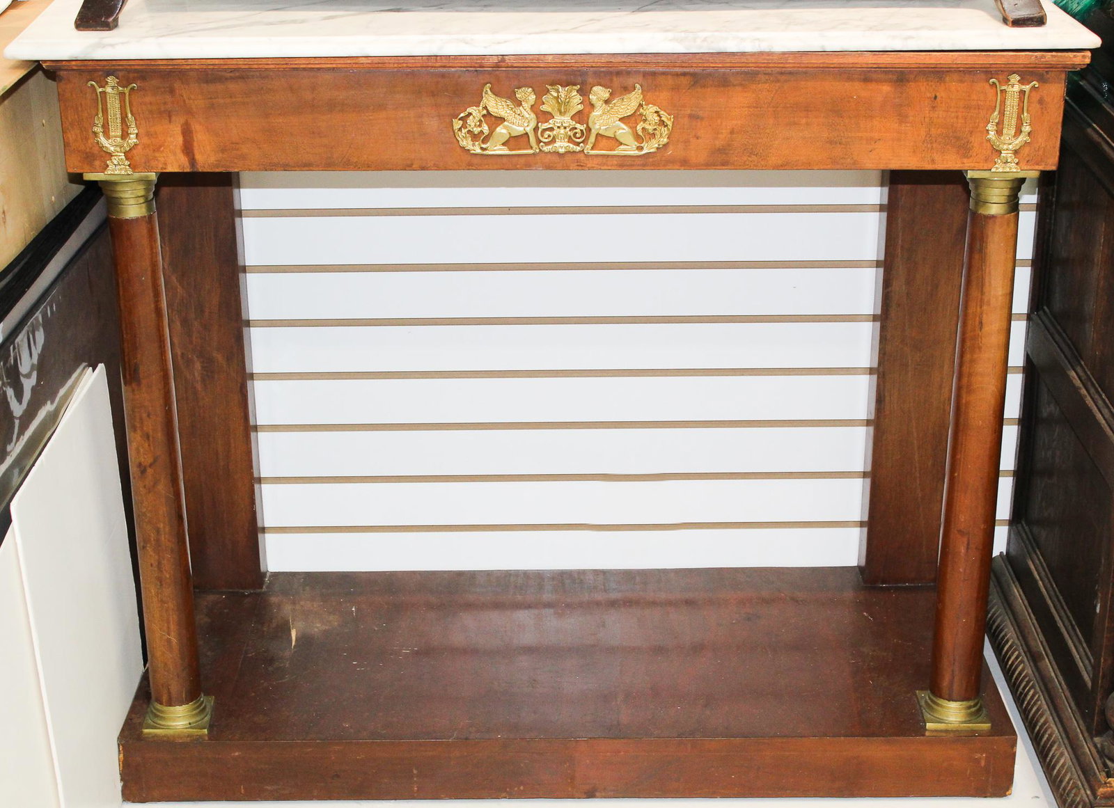 20th C. French Empire Console Table: 20th C. French Empire Console table with the figure of a woman's head, lions body and birds wing crest. Size: 44 x 18 1/2 x 37 in.
