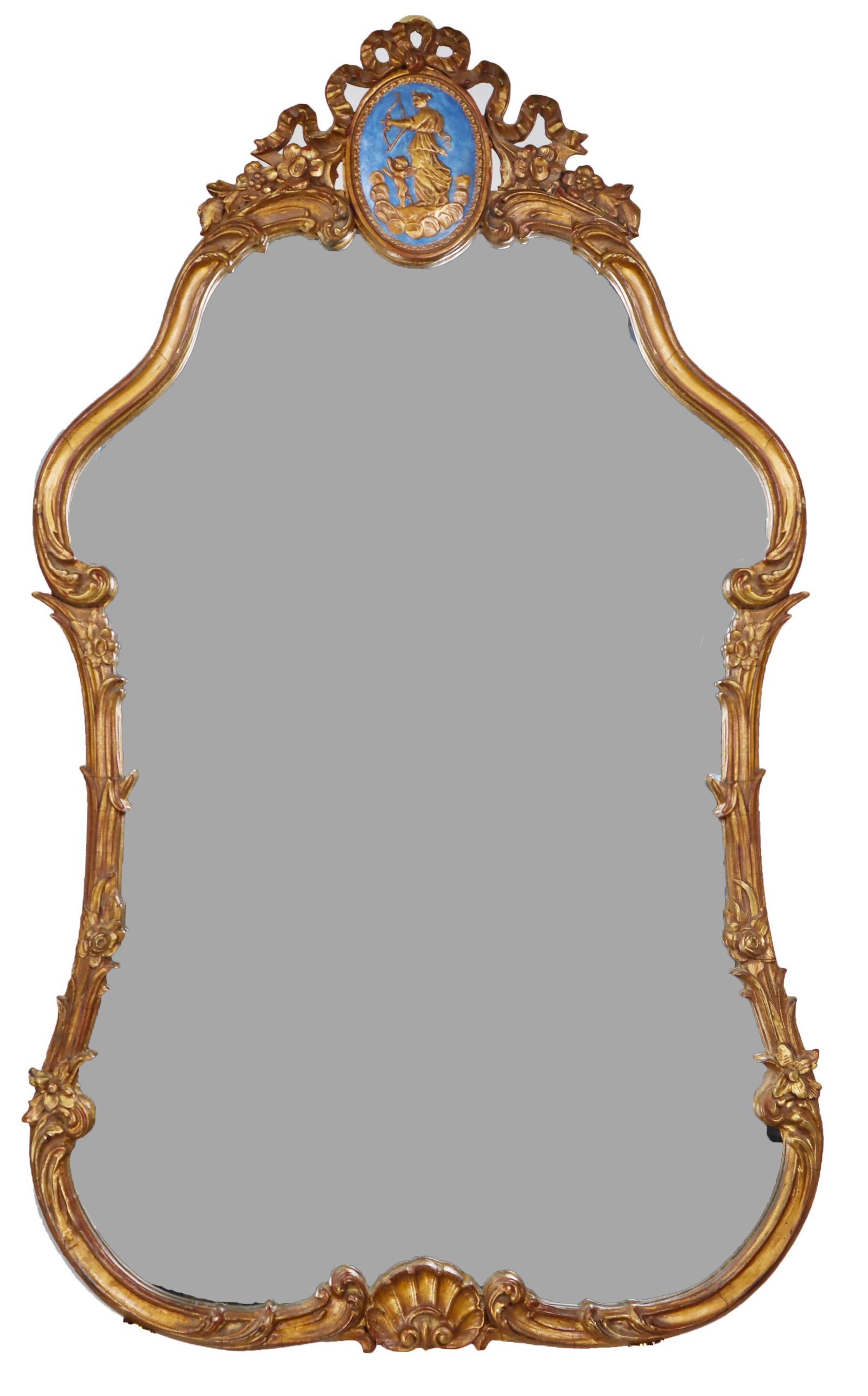 French Style Shaped Gilt Mirror: Lovely shaped wall mirror with ornate gilt wood ribbon decoration and carved shell motif, the blue cameo-like image at the top depicts Venus and Cupid. Size: 43 x 25 in.Please note that all sales are 