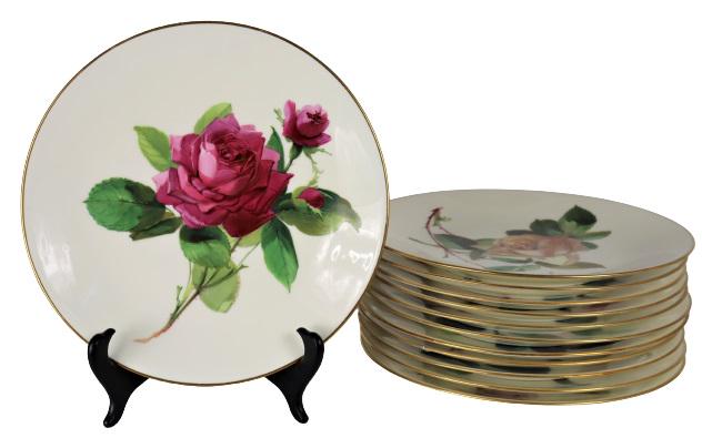 Set of 12 English Minton Gilt Rim Floral Plates: Gorgeous set of antique English Minton porcelain fired gold display plates. Each plate a different rose, hand-painted in varying shades of pink. One plate has staple repairs, two other plates have a h