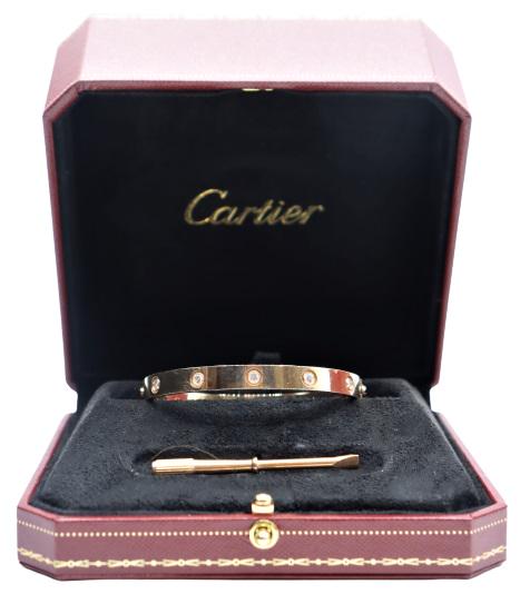 Cartier "Love" Bracelet w/ Diamonds, Size 17, 18K: Stamped "Cartier"Clean quality diamonds, 10 in all, likely SI1.Weight: 22 dwt (18K)Bracelet measures 17 cm, for a small wrist. Size of box: 5 1/4 x 5 1/4 x 3 in.Please note that all sales are final. N