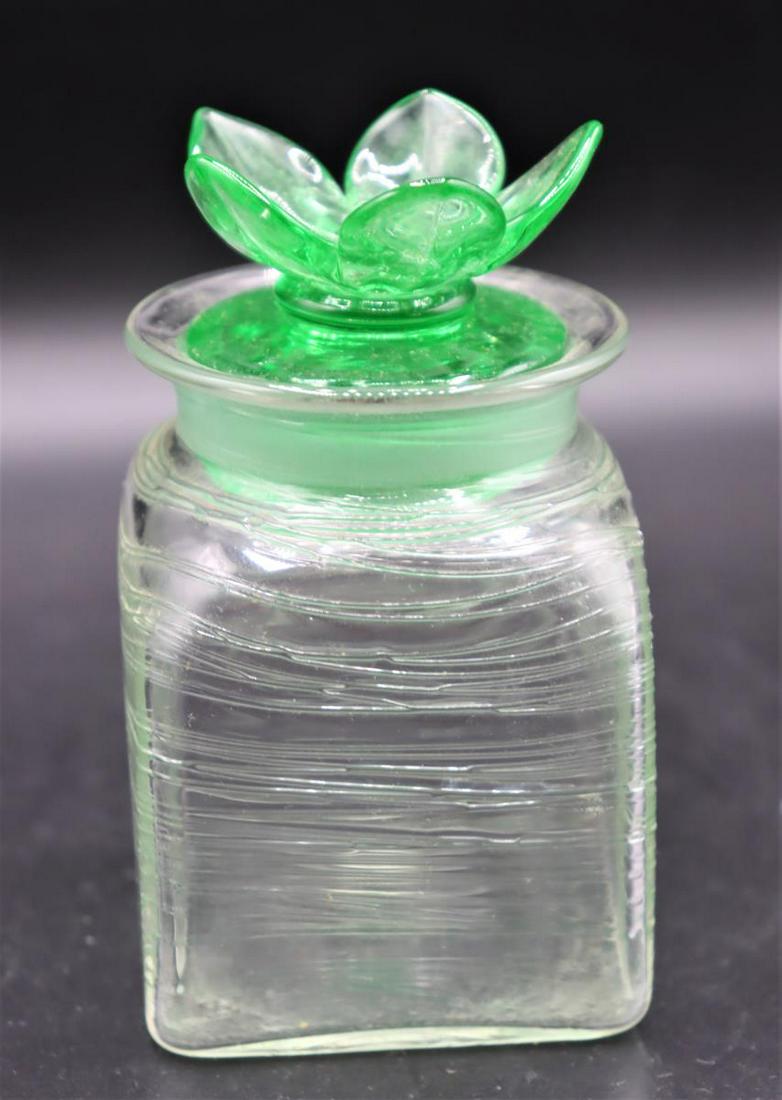 Steuben Green Threaded Vanity Jar: With flowered stopper. 3 x 3 x 4 in.Provenance: Estate of Dr. Arnold Werschky in Sausalito, California.