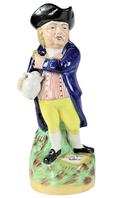 Staffordshire Ware Porcelain Figure Vase: This is a lovely painted Staffordshire Ware porcelain figure vase with handle. Maker mark underneath and by the man's feet it reads: "Hearty Good Fellow". Size: 11 x 4 x 4 in.Please note that all sale