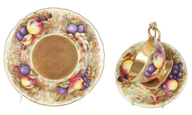 3 Pcs. Aynsley England China Tea Cup, 2 Saucers: 3 pcs set includes Aynsley England Bone China Tea cup and 2 sauces. Hand painted gilt rimmed. Still life of fruit. Tea cup has gilt rim, handle, base and interior of cup.Sizes: Plates are 8 in. and 6