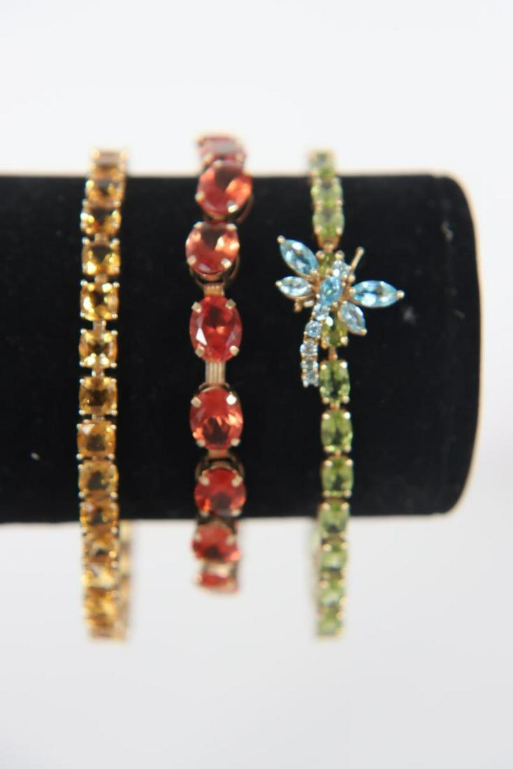 (3) Ladies Gold & Inset Gem Bracelets, 20 DWT: 2 ladies bracelets, both marked MEXICO 14k gold and 1 10k gold bracelet (not marked- tested). Inset gems with pendants. Approximate weight: 20 DWT. Size: 3 in.Please note that all sales are final. No