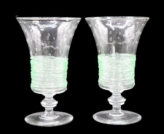 (2) Steuben Controlled Bubble Wine Glasses: Two lovely Steuben controlled bubble wine glasses with green threading. Size of each: 6 1/2 x 4 in.Please note that all sales are final. No refunds will be given under any circumstances.