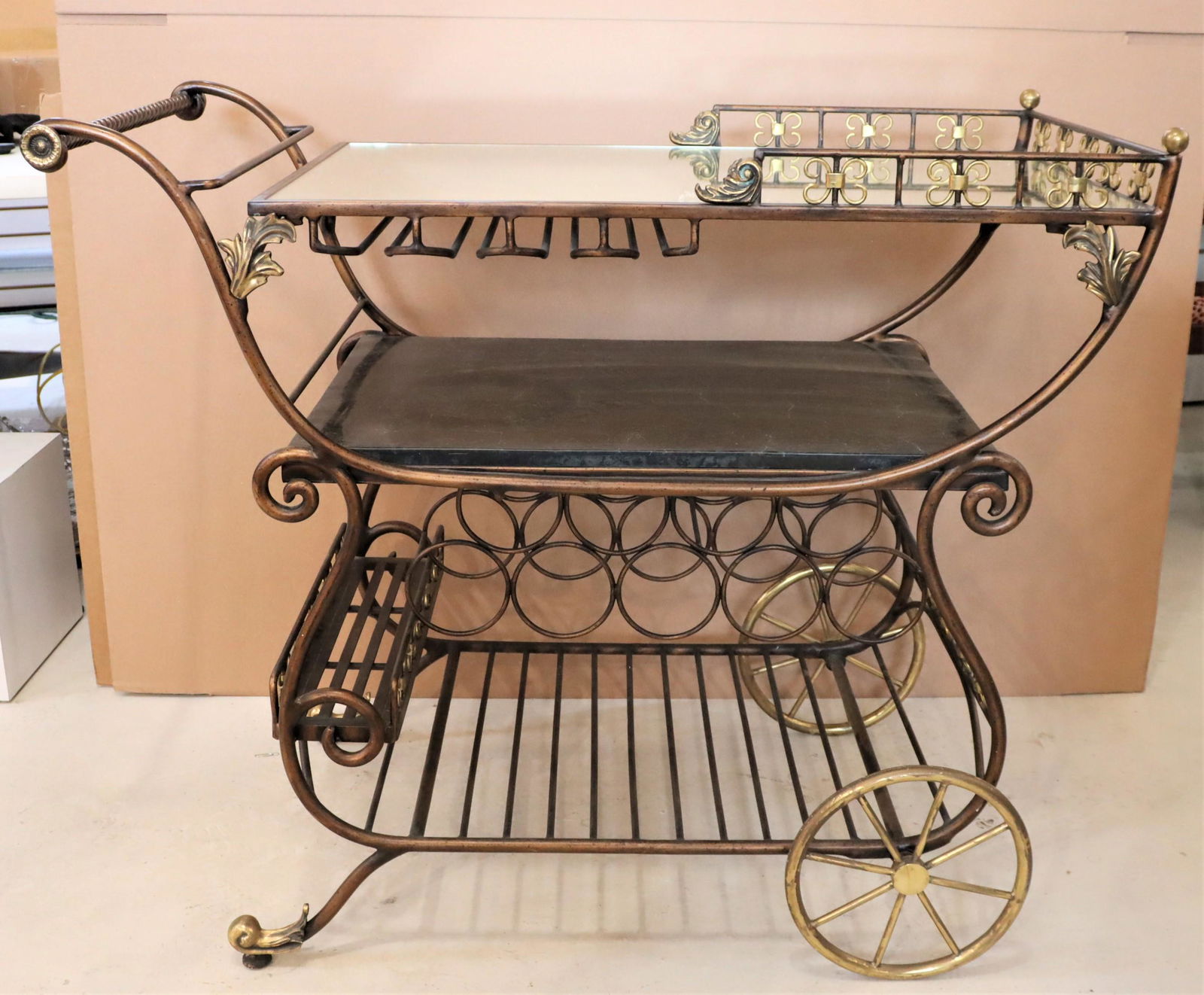 20th C Gilt Metal Bar Cart: In the manner of Maitland Smith bar cart with attention to detail, a reticulated gallery and faux marble shelf.Size: 40 x 21 x 34 in. Please note that all sales are final. No refunds will be given und