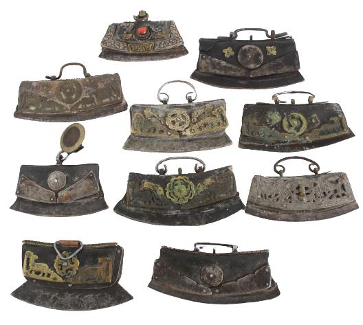 (10) Tibetan Metal & Leather Chuckmucks: 19th Century. Of typical form, each with a convex steel striking plate and chased metal mounts fitted to a leather pouch, some with hardstone or coral mounts. Size: 6 1/8 x 3 1/8 in.