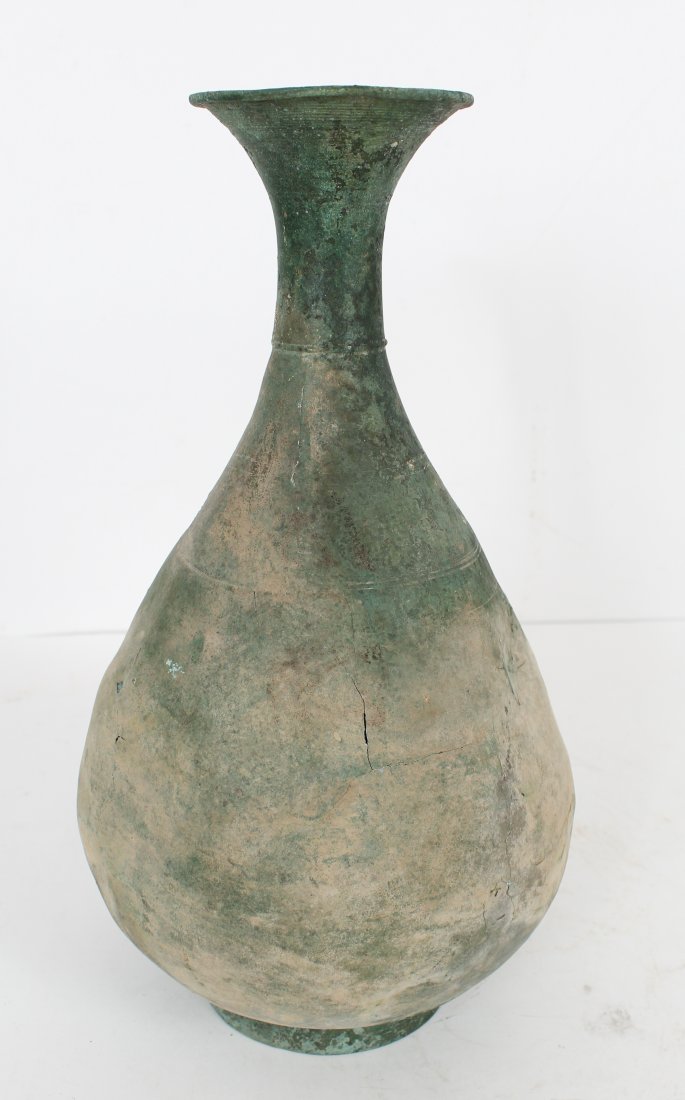 Rare Korean Koryo Kingdom Patinated Bronze Vessel: Dating from 918 through 1395 CE. The underside with a paper label with the number8477.09. The thin-walled pear-form body with a tapering cylindrical neck continuingto an out-turned rim, on a raised ci
