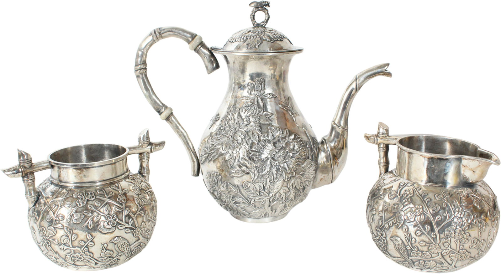 (3) Pc Chinese Silver Tea Set 40 OZT: (3) Pc Chinese Silver Tea Set , marked on the underside. Bamboo handles with Japanese cherry blossom motif. The teapot has peonies and a dragonfly finial. Approximately 40 OZT.Size of teapot: 10 x 4 3